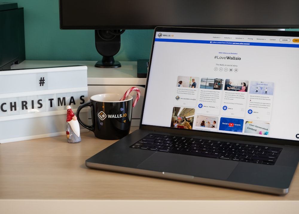 a laptop computer sitting on top of a wooden desk