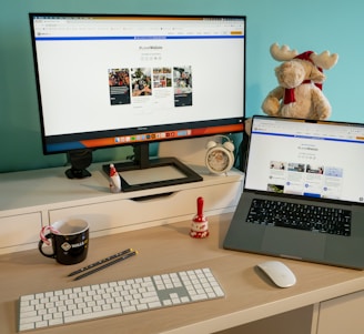 a desk with a laptop and a computer monitor