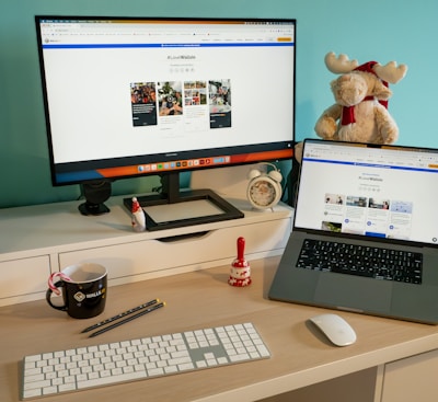 a desk with a laptop and a computer monitor