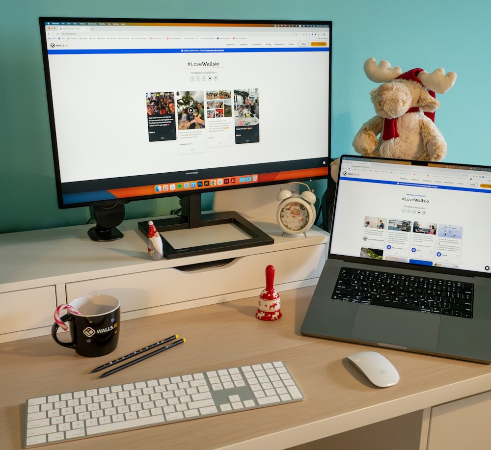 a desk with a laptop and a computer monitor