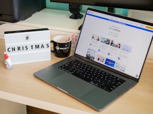 A cozy digital workspace with a laptop displaying software sales charts and holiday decorations.