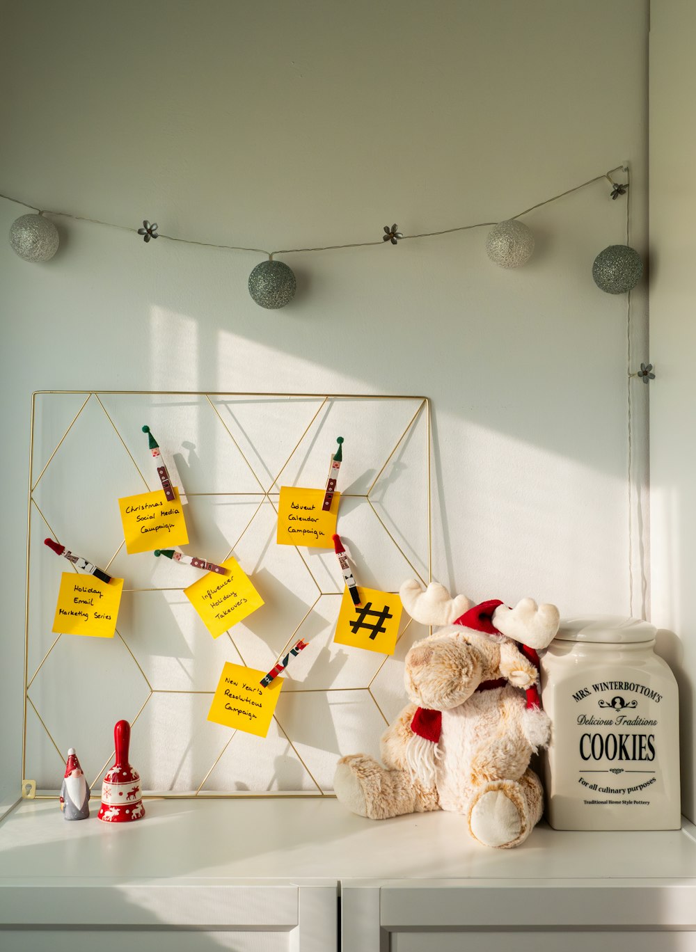 a teddy bear sitting on top of a white dresser