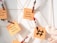 Sticky notes attached with festive-themed clothespins are displayed on a metallic grid, featuring handwritten ideas for holiday marketing campaigns. A small plush heart is also visible.