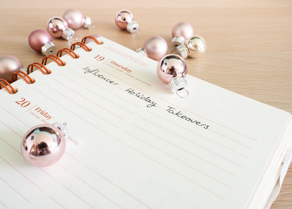 a notepad with a bunch of christmas ornaments on top of it