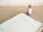 A planner opened to a page for Monday, the 9th, with a note reading 'Christmas Social Media Campaign.' A small decorative Santa figure is positioned on a wooden desk surface beside the planner.