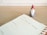 A planner opened to a page for Monday, the 9th, with a note reading 'Christmas Social Media Campaign.' A small decorative Santa figure is positioned on a wooden desk surface beside the planner.