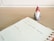 A planner opened to a page for Monday, the 9th, with a note reading 'Christmas Social Media Campaign.' A small decorative Santa figure is positioned on a wooden desk surface beside the planner.