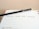 A black pencil with a yellow eraser lies diagonally across an open planner, with the words 'Christmas Social Media Campaign' written on one of the lined pages. The date 'Tuesday 10' is visible at the bottom of the page.