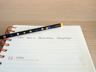 a notepad with a pen sitting on top of it