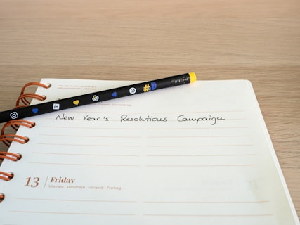 a notepad with a pen sitting on top of it