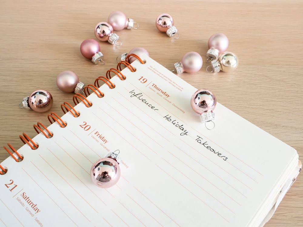 a notepad with a bunch of christmas ornaments on top of it