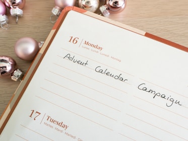 A bright calendar on a wall marking a weekend launch deadline with sticky notes and reminders.