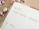 A planner or calendar is open to Monday, the 16th, with the words 'Advent Calendar Campaign' written in black ink. Surrounding the planner are shiny, metallic Christmas ornaments in shades of pink and silver. The planner has a wooden table underneath.