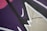 Abstract street art featuring bold, angular shapes and overlapping lines. The composition consists of dark purple, pink, and beige backgrounds, accentuated by black and white lines.