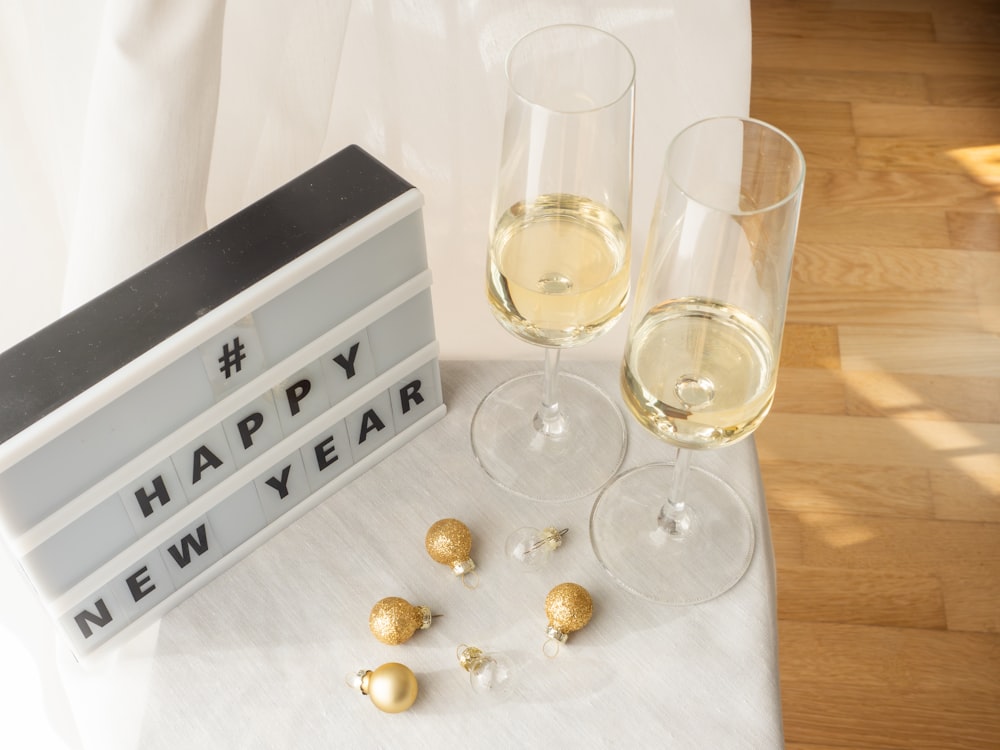 a couple of glasses of wine sitting on top of a table