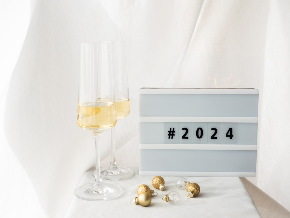 a glass of wine next to a sign that says 2012