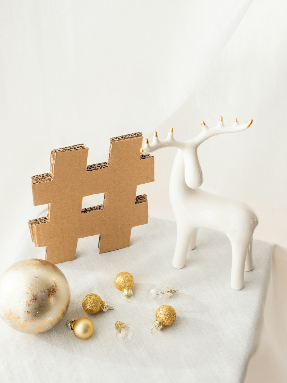 a white reindeer figurine next to a cardboard box