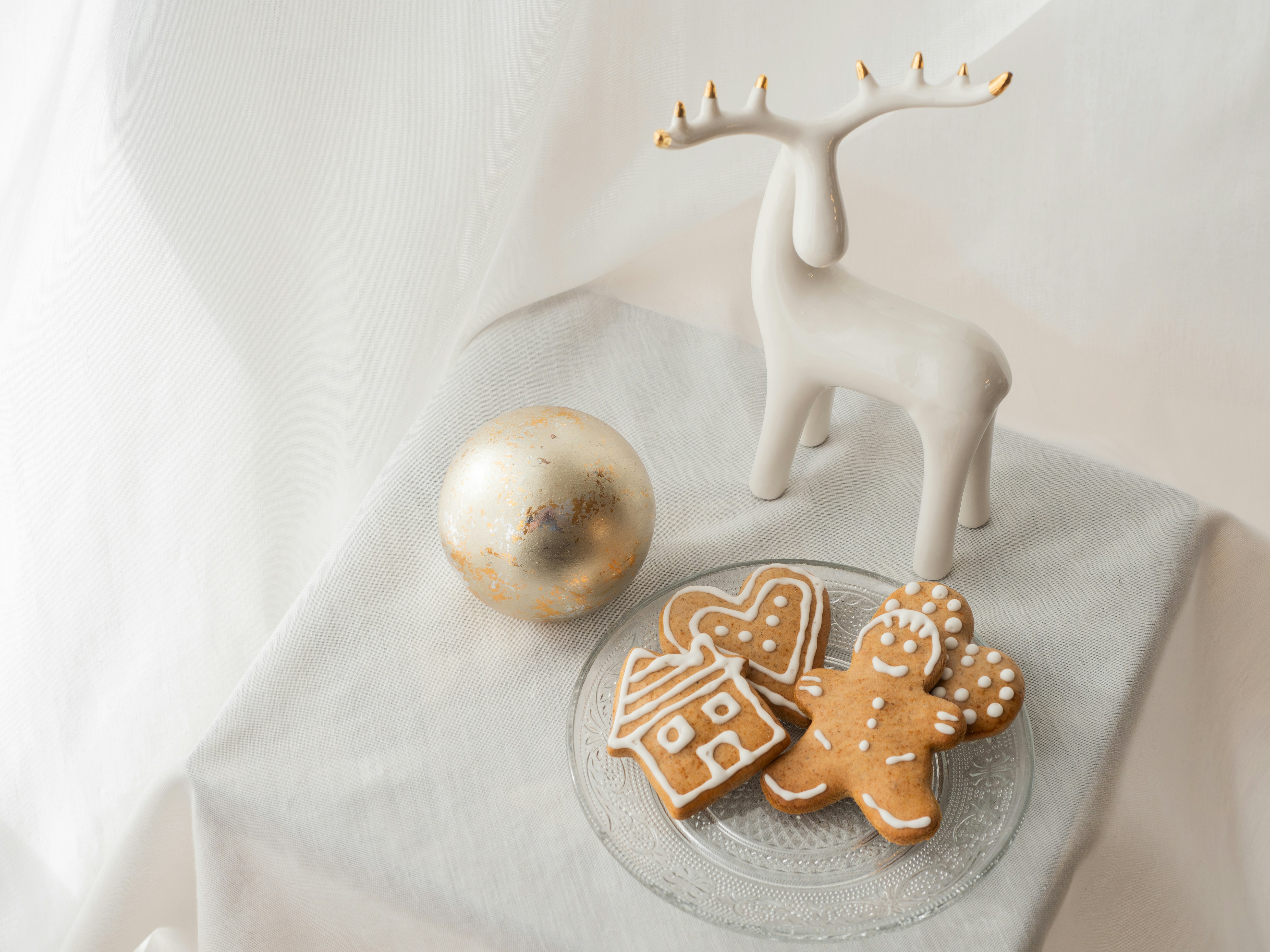 a glass plate topped with cookies and a reindeer figurine