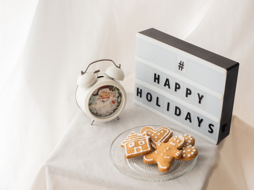 a plate of ginger cookies next to an alarm clock