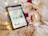 A cozy home setup with a person browsing an online store on a tablet.