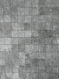 Smooth limestone tiles arranged in a neat pattern.