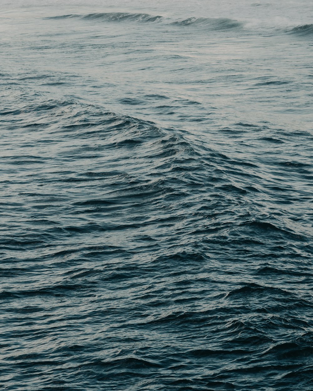 a person riding a surfboard on a large body of water