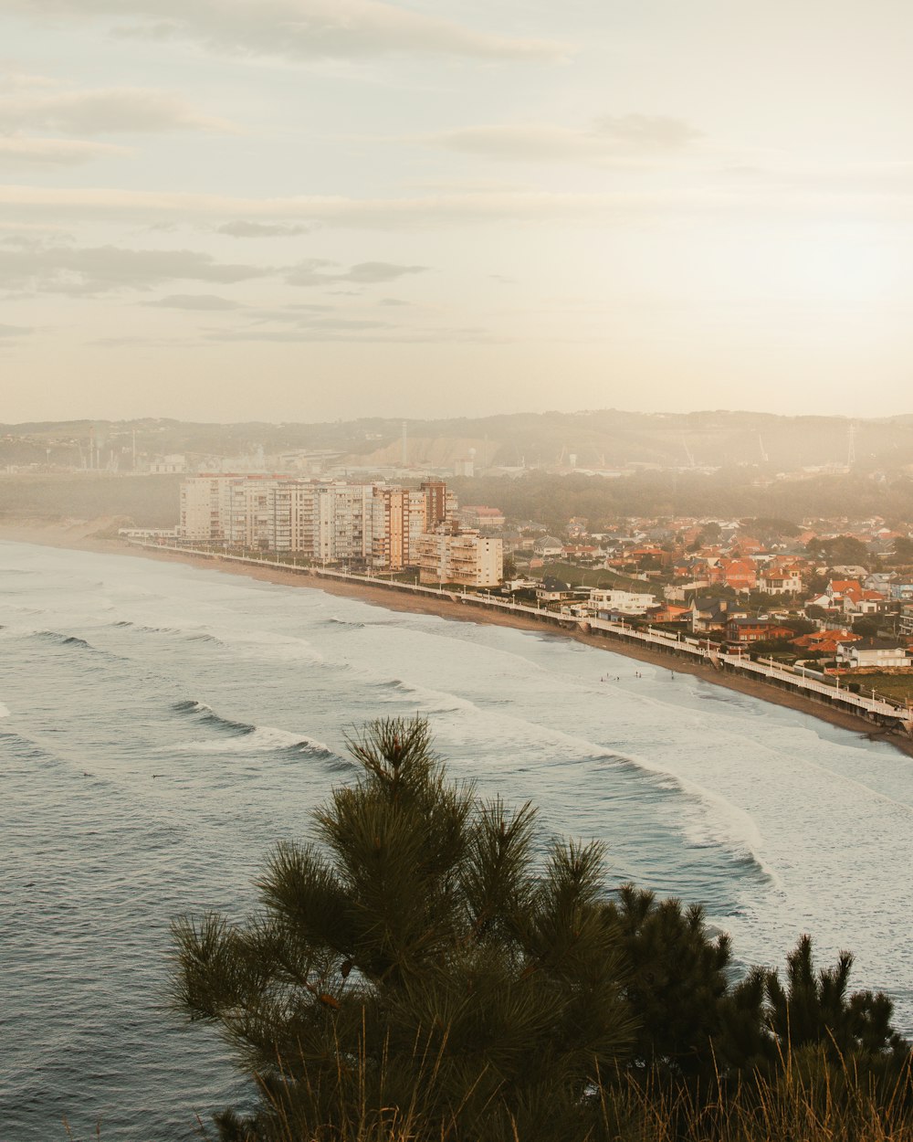 a view of a beach with a city in the background