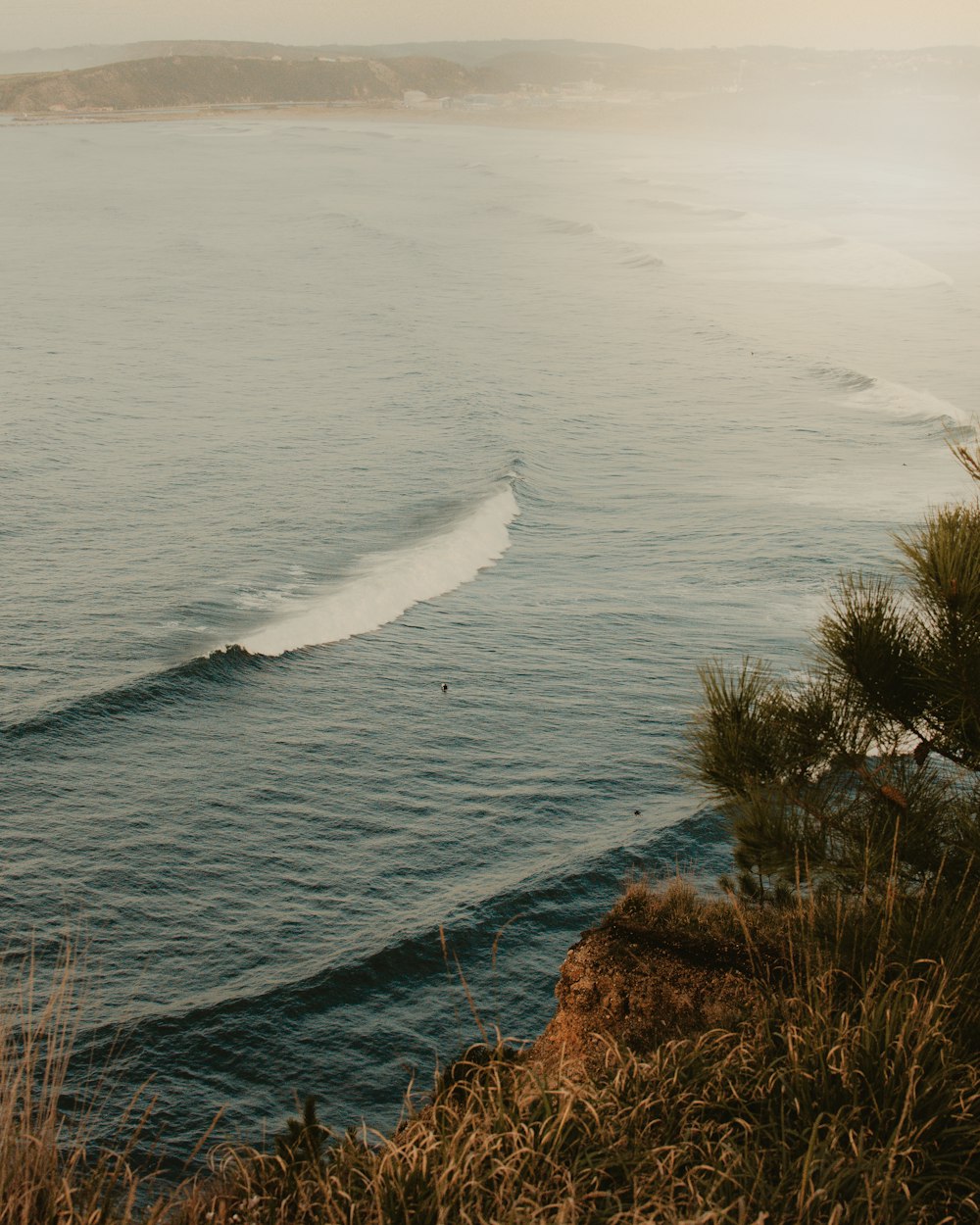 a person riding a surfboard on a wave in the ocean