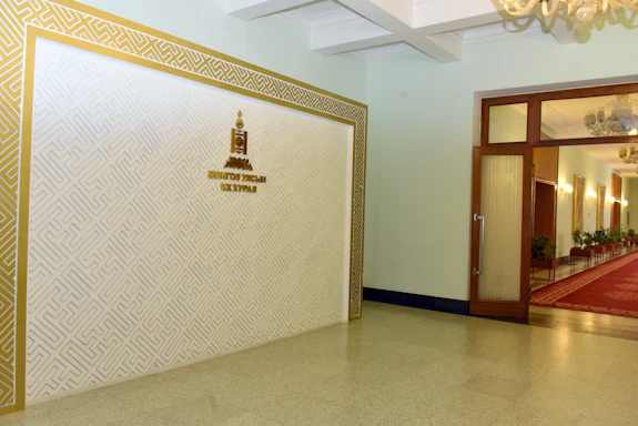 A welcoming office space with a laurel wreath emblem on the wall, symbolizing honor and achievement.