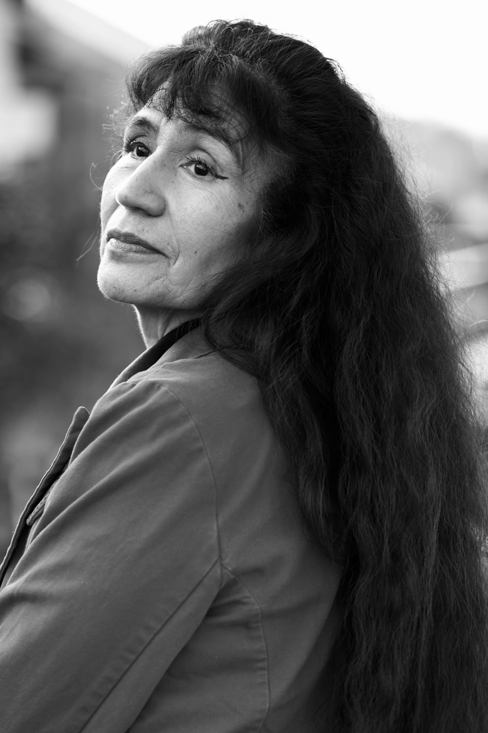 a black and white photo of a woman with long hair