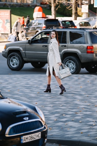 A woman walking in a city wearing a chic autumn coat.