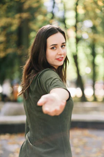 a woman pointing at something in the air