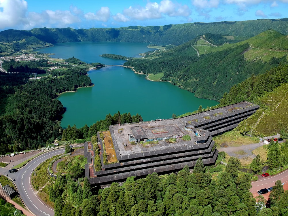 an aerial view of a large building in the middle of a forest