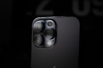 Close-up of a high-tech camera module glowing softly against a dark background.