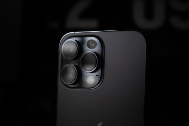 Close-up of a high-tech camera module glowing softly against a dark background.