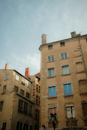 a tall building with lots of windows next to other buildings