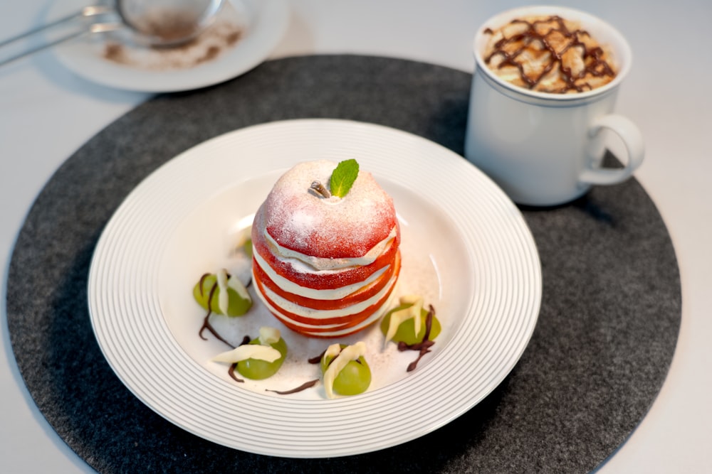 a white plate topped with an apple covered in fruit