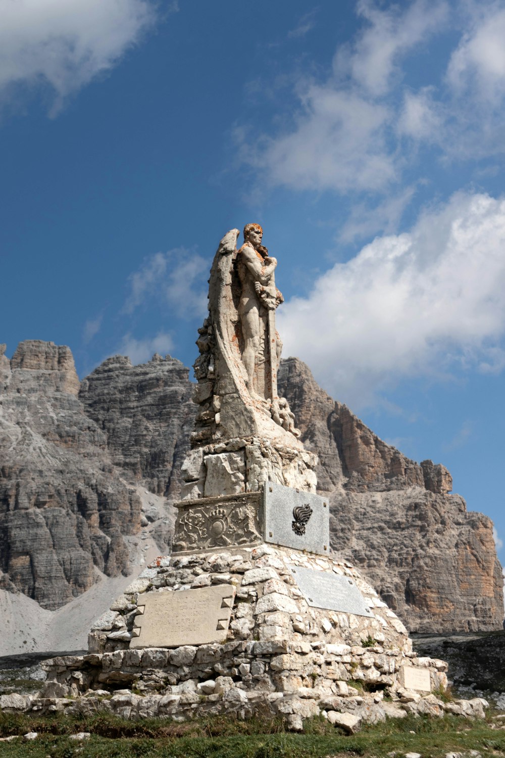 una estatua de un hombre de pie en la cima de una montaña