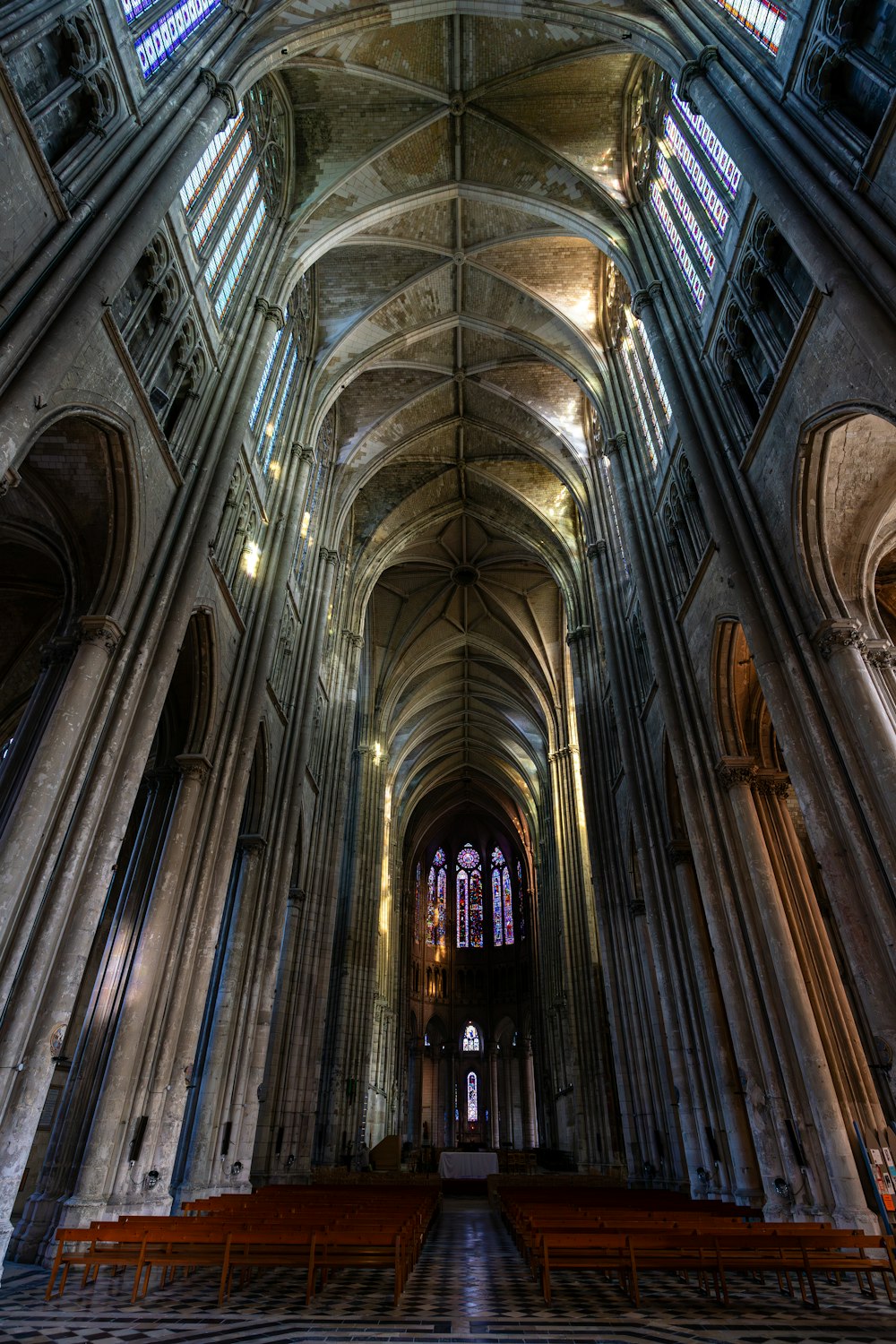 a cathedral with pews and stained glass windows