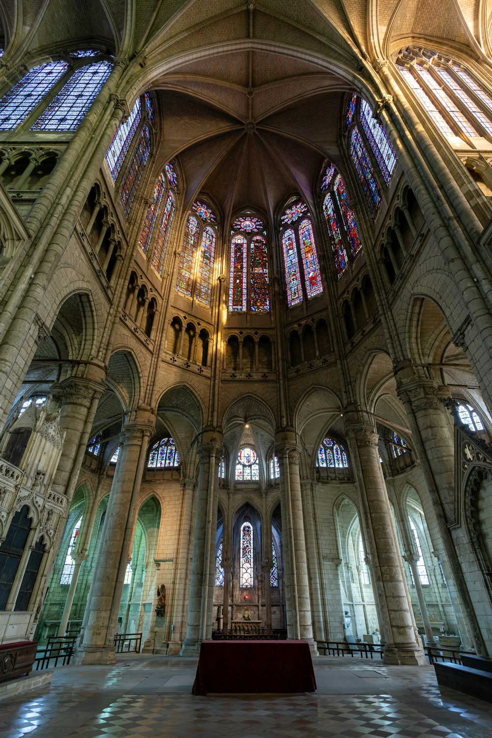 the inside of a cathedral with stained glass windows