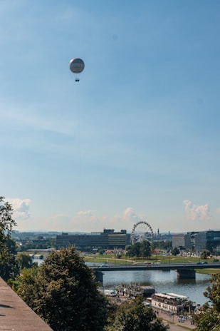 A happy family enjoying their peaceful hot air balloon ride, smiling against the city skyline.