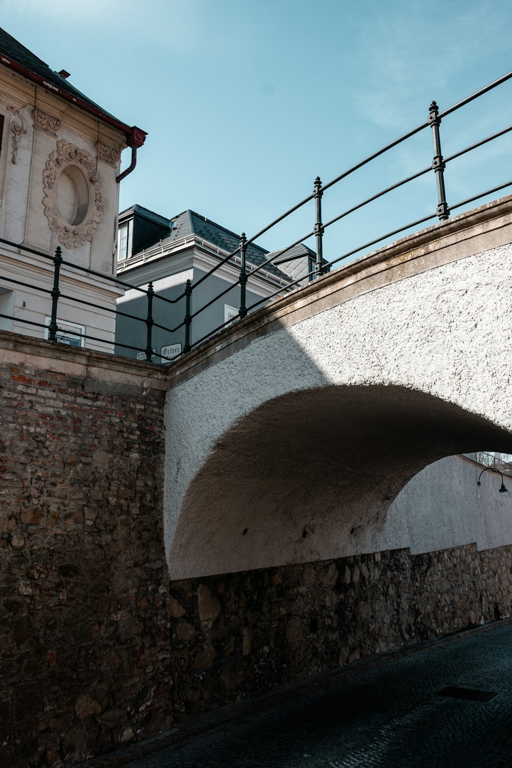 a bridge over a body of water with a building in the background