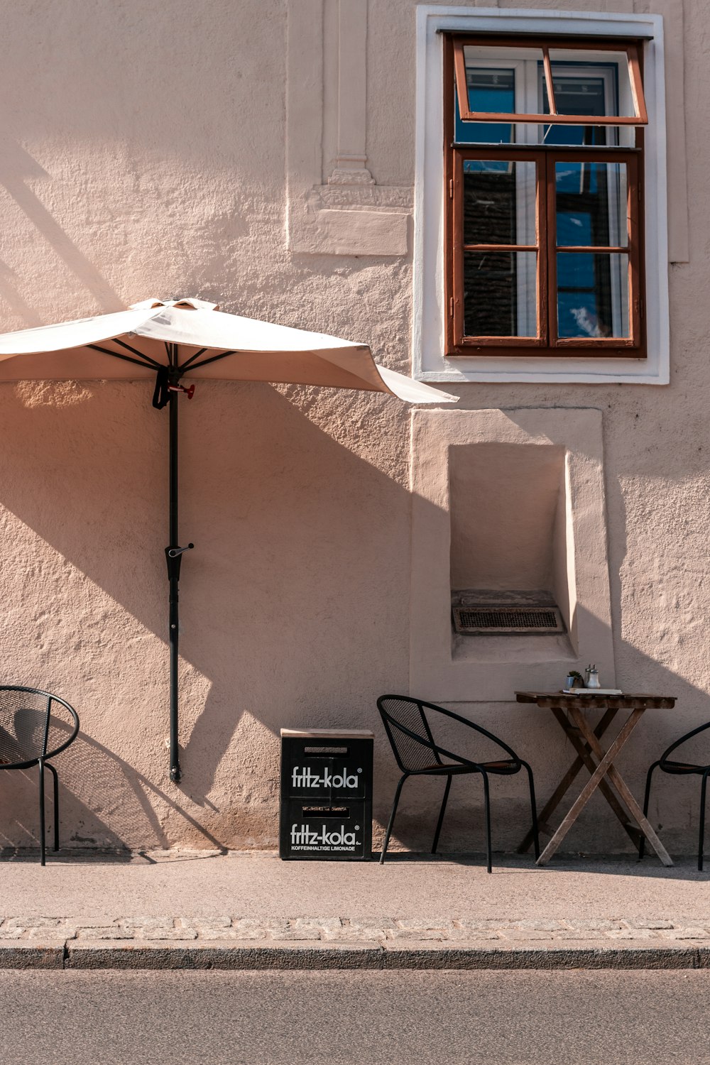 a couple of chairs sitting under an umbrella