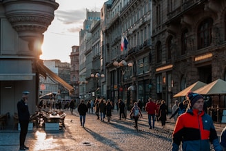 A vibrant street scene in Damascus with traditional markets and historic buildings under a warm sunset.