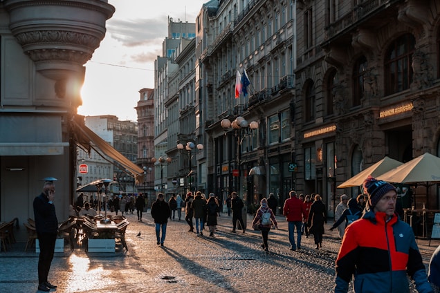 A vibrant street scene in Damascus with traditional markets and historic buildings under a warm sunset.