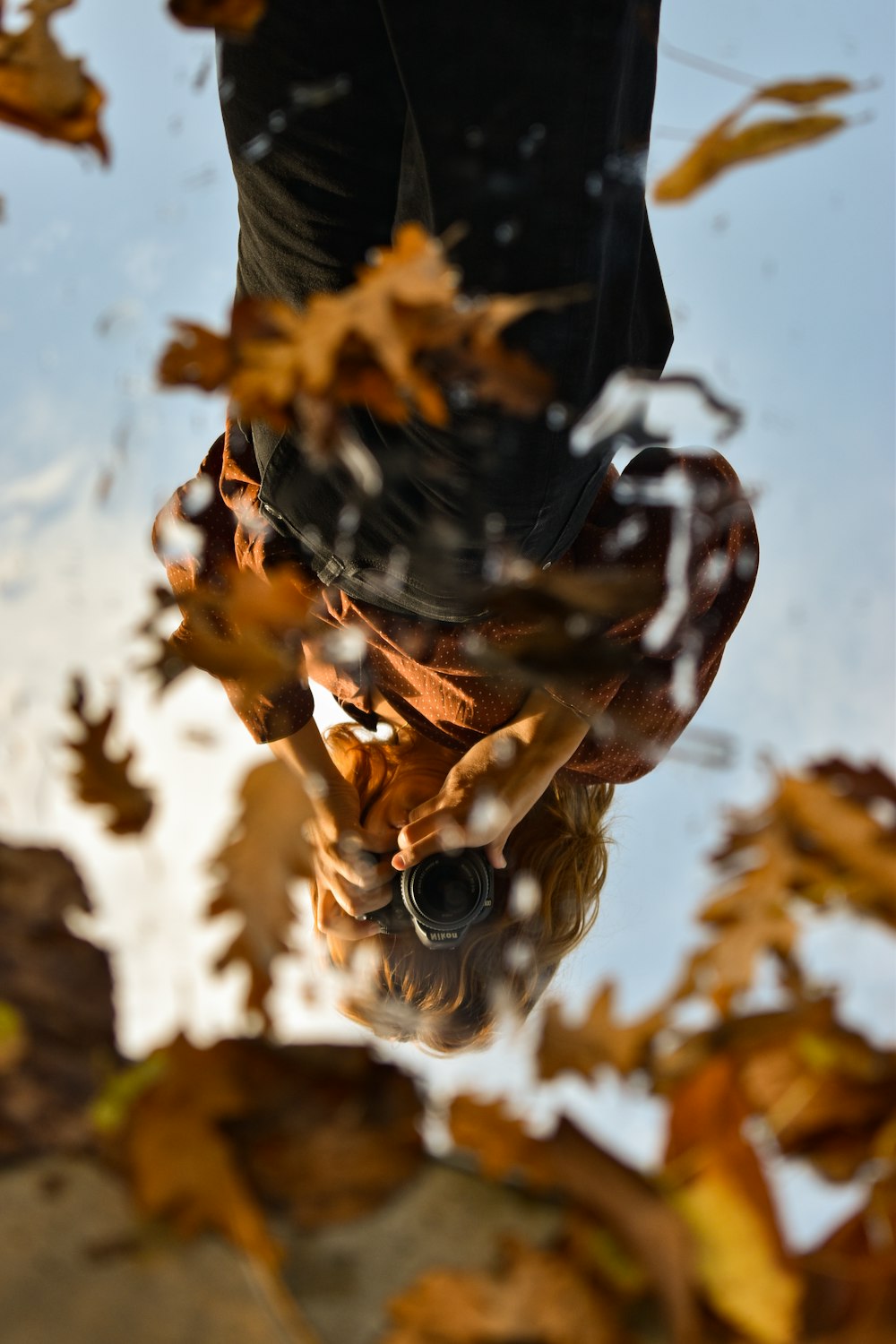 a reflection of a person in a puddle of water