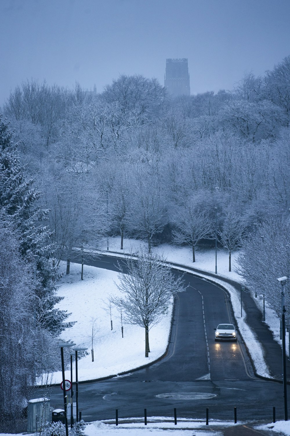 a car driving down a snow covered road