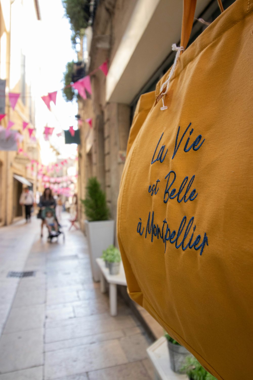 a shopping bag with writing on it hanging from a line