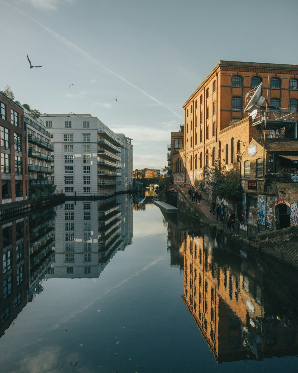 a river running through a city next to tall buildings