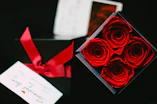 a box of roses and a card on a table